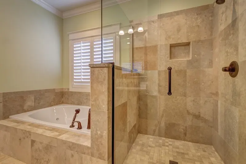 Travertine-tiled bath and shower