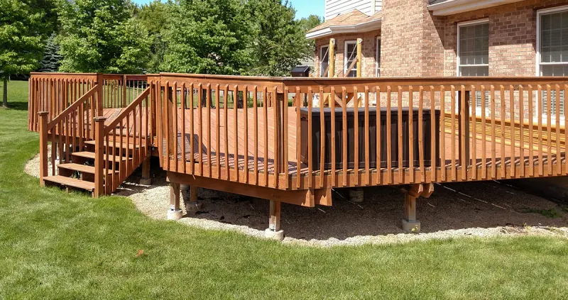 Wood deck with stairs in a green yard