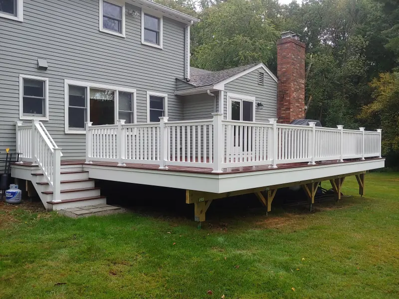 White-railed deck behind a gray house